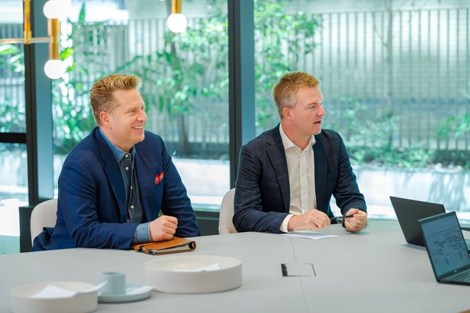 Two Quinn Allan consultants in a meeting room with a client